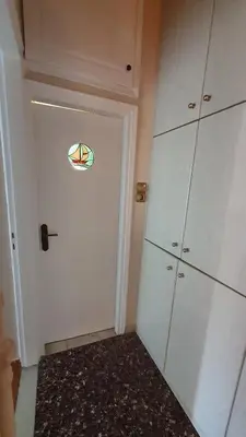 a room with a white door with a window on it at Marianas Inn in Athens