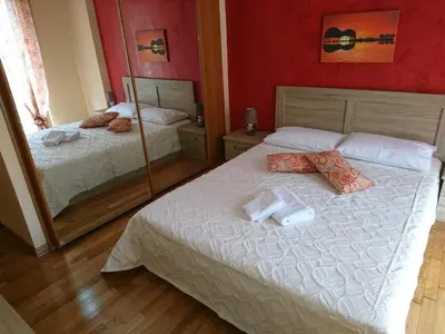 a bedroom with two beds and a mirror at Marianas Inn in Athens
