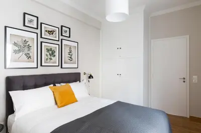 a bedroom with a bed with an orange pillow at Chic Flat in the Heart of Athens by UPSTREET in Athens