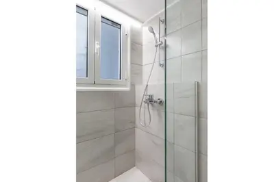 a bathroom with a shower and a window at Chic Flat in the Heart of Athens by UPSTREET in Athens