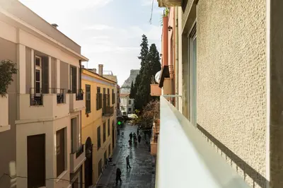 a view from an alleyway between buildings at Chic Flat in the Heart of Athens by UPSTREET in Athens