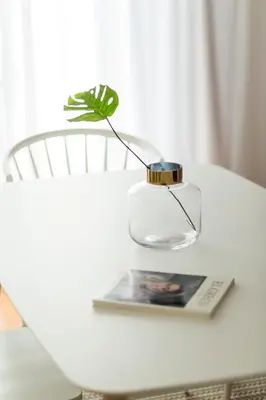 a table with a vase and a book on it at Chic Flat in the Heart of Athens by UPSTREET in Athens