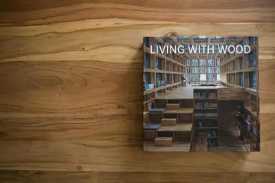 a book on living with wood on a wooden wall at Stylish and Spacious 2BD - Thiseio by UPSTREET in Athens
