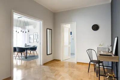 a living room with a table and a dining room at Acropolis Core Bright & Modern Apartment by UPSTREET in Athens