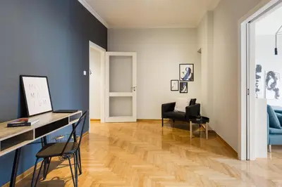 a living room with a desk and a chair at Acropolis Core Bright & Modern Apartment by UPSTREET in Athens