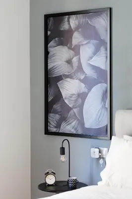 a bedroom with a bed with a picture on the wall at Acropolis Heart 1BD Apartment in Plaka by UPSTREET in Athens