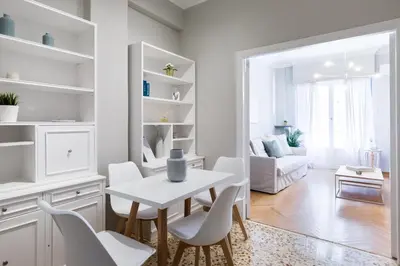 a white dining room with a white table and chairs at Acropolis Heart 1BD Apartment in Plaka by UPSTREET in Athens