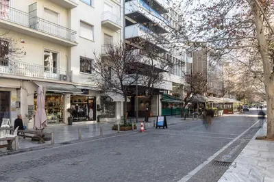 an empty street in a city with buildings at Acropolis Heart 1BD Apartment in Plaka by UPSTREET in Athens