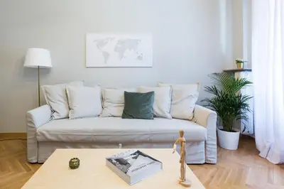 a living room with a couch and a table at Acropolis Heart 1BD Apartment in Plaka by UPSTREET in Athens