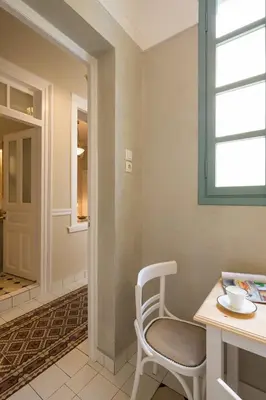 a room with a chair and a table and a window at Artdecoathens in Athens