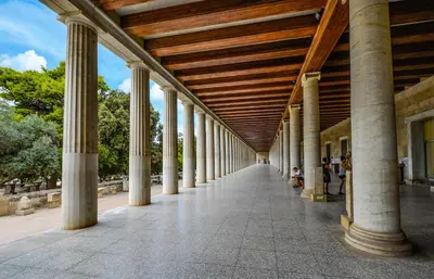 an arcade of a building with columns and a wooden ceiling at Artdecoathens in Athens