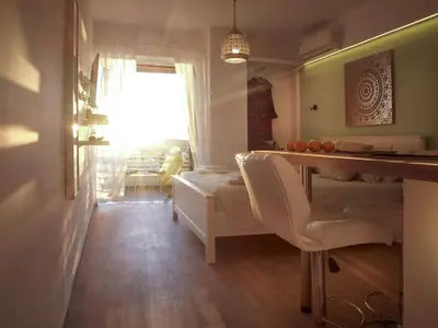 a living room with a table and a couch at Seaside Secret by BluPine in Athens