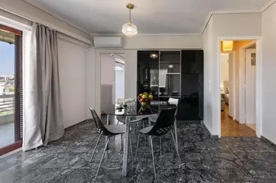 a dining room with a table and chairs at Seaside Secret by BluPine in Athens