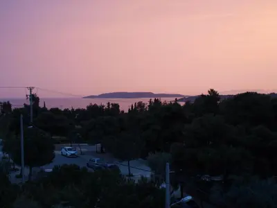 a view of the bay from a parking lot at sunset at Seaside Secret by BluPine in Athens