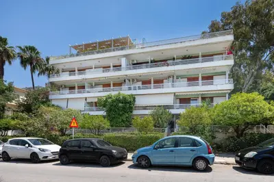 a group of cars parked in front of a building at Seaside Secret by BluPine in Athens
