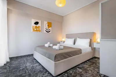 a bedroom with a large bed in a room at Seaside Secret by BluPine in Athens