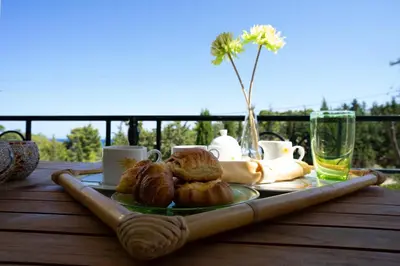 a table with croissants and cups and a tray of pastries at Apollo complex 1 in Porto Rafti