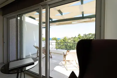 a room with a sliding glass door leading to a balcony at Apollo complex 1 in Porto Rafti