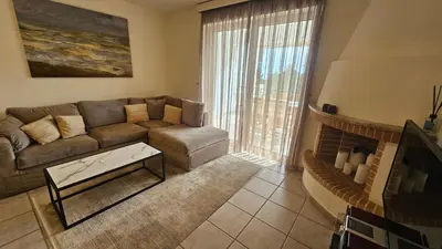 a living room with a couch and a table at Apollo complex 1 in Porto Rafti