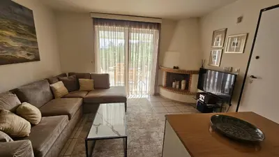 a living room with a couch and a tv at Apollo complex 1 in Porto Rafti