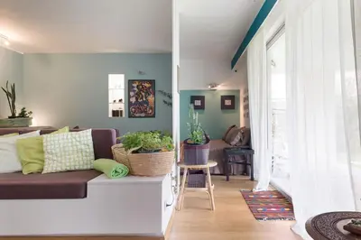 a living room with a couch and a table at Garden Studio 55 s.m. in Athens