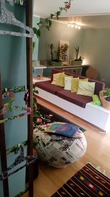 a living room with a couch and a bean bag chair at Garden Studio 55 s.m. in Athens