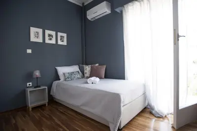 a bedroom with a bed with a teddy bear on it at Modern-Vintage apartment by Acropolis museum in Athens