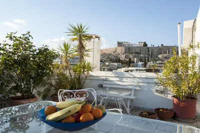 a bowl of fruit on a glass table on a balcony at Modern-Vintage apartment by Acropolis museum in Athens