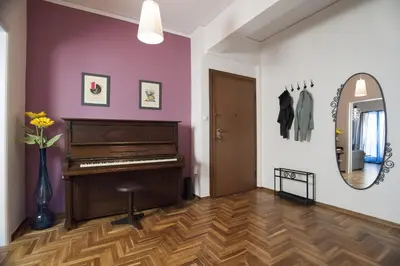 a room with a piano and a vase of flowers at Modern-Vintage apartment by Acropolis museum in Athens