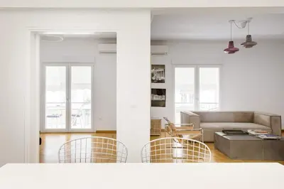 a living room with a couch and chairs at Bright and roomy apartment, in the heart of Athens in Athens