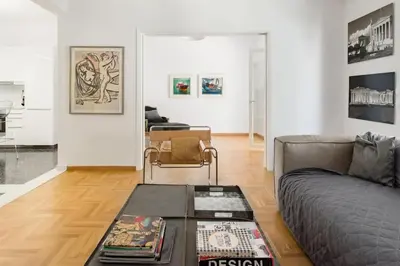 a living room with a couch and a table at Bright and roomy apartment, in the heart of Athens in Athens