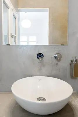 a white sink in a bathroom with a mirror at Bright and roomy apartment, in the heart of Athens in Athens