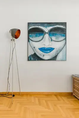 a painting of a woman with sunglasses on a wall at Bright and roomy apartment, in the heart of Athens in Athens
