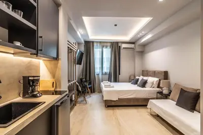 a hotel room with a bed and a couch at Furla Apartments Athens in Athens