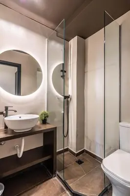 a bathroom with a sink and a glass shower at Furla Apartments Athens in Athens