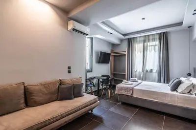a hotel room with a couch and a table at Furla Apartments Athens in Athens