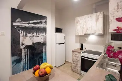 a kitchen with a bowl of fruit on the counter at Blue Ark Stylish Athens in Athens