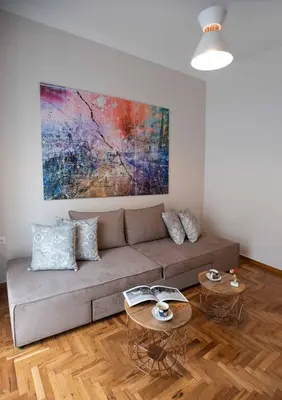 a living room with a couch and two tables at Blue Ark Stylish Athens in Athens