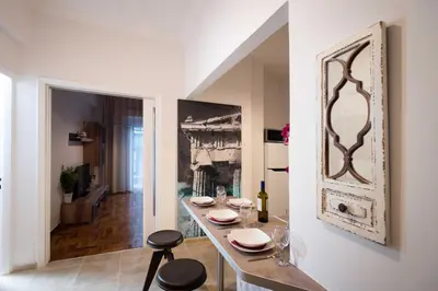 a dining room with a table and two stools at Blue Ark Stylish Athens in Athens