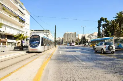 a white tram on a city street with cars at Athens heart, Syntagma metro studio in Athens