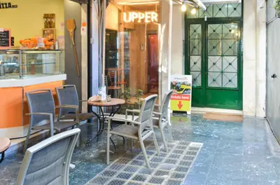 a table and chairs in front of a restaurant at Athens heart, Syntagma metro studio in Athens