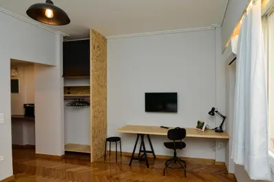 a room with a table and two chairs and a desk at Athens heart, Syntagma metro studio in Athens