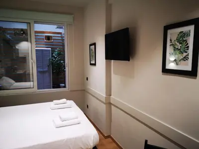 a bedroom with a bed with two towels on it at Syntagma Square Athenian apartments in Athens