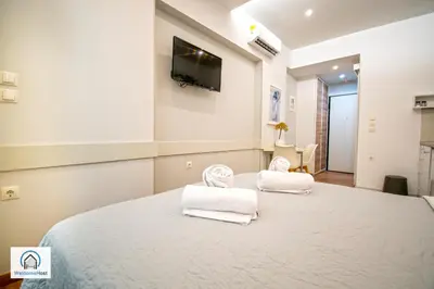 a bedroom with a large bed with towels on it at Syntagma Square Athenian apartments in Athens