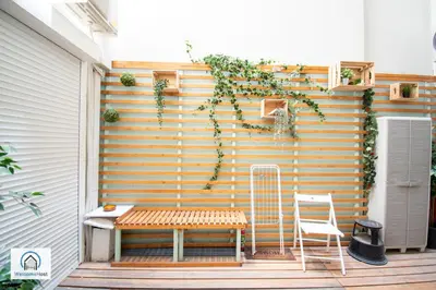 a bench and a chair on a patio at Syntagma Square Athenian apartments in Athens