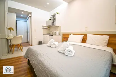 a bedroom with a large bed with towels on it at Syntagma Square Athenian apartments in Athens