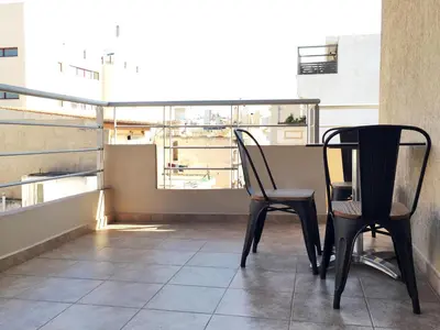 two black chairs sitting on top of a balcony at Mc Queen Rooms & Apartments in Athens
