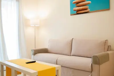 a living room with a couch and a table at Cozy Bright Apartment in Athens