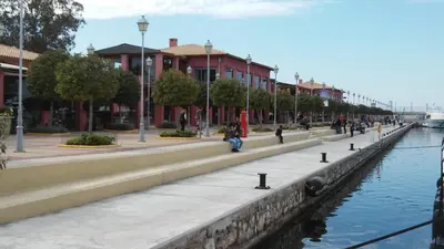 a row of buildings next to a body of water at Cozy Bright Apartment in Athens