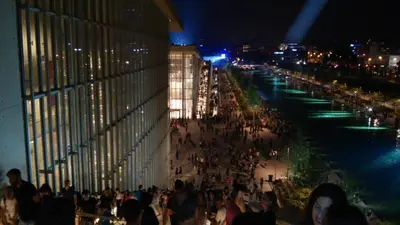 a crowd of people walking down a street at night at Cozy Bright Apartment in Athens